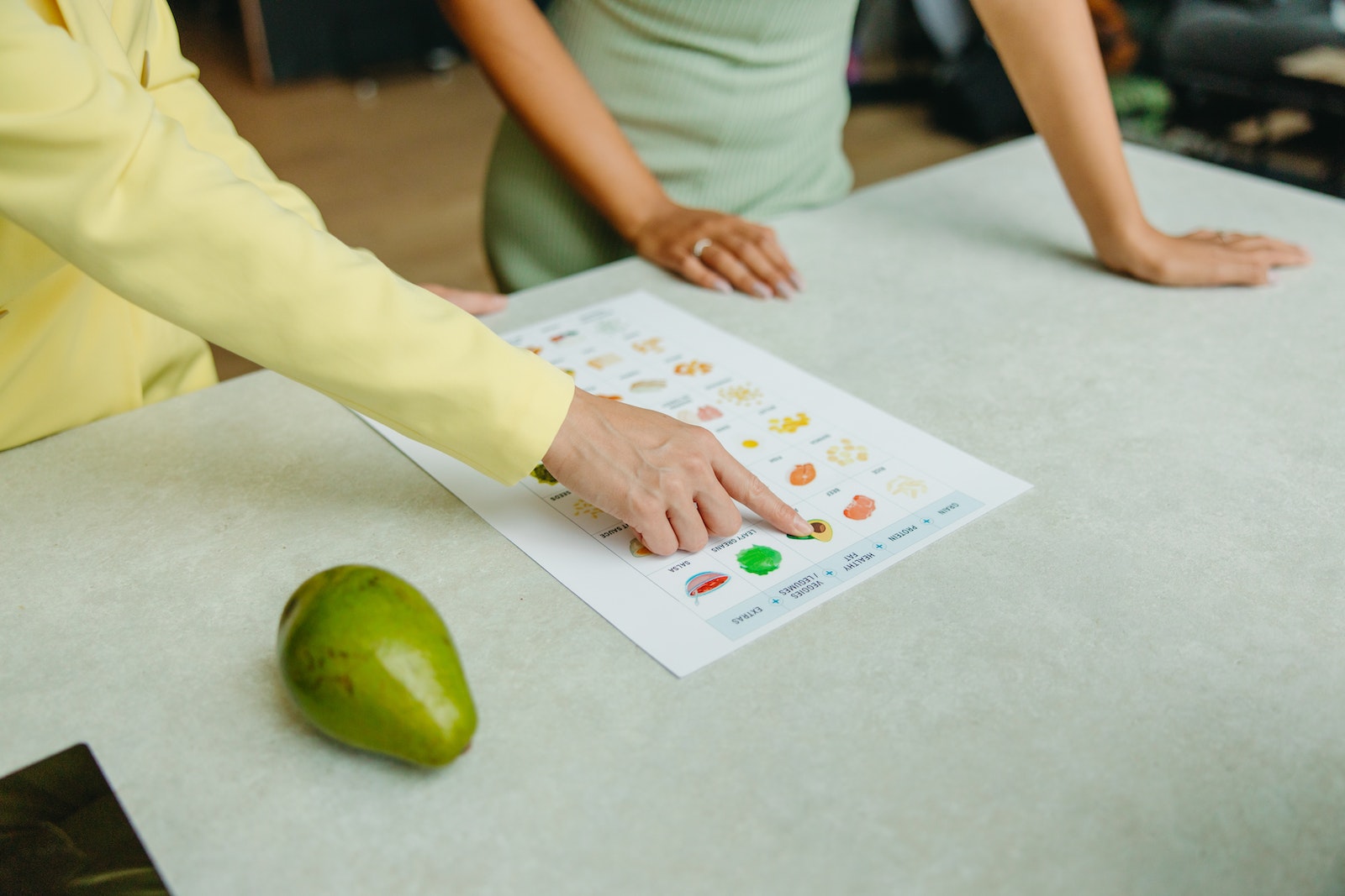 Two adults reviewing printed nutition information